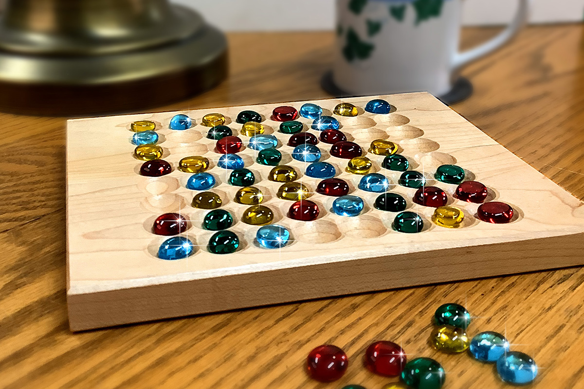 A BoxOff tray part-way through a game, coloured pieces arranged in the grid
